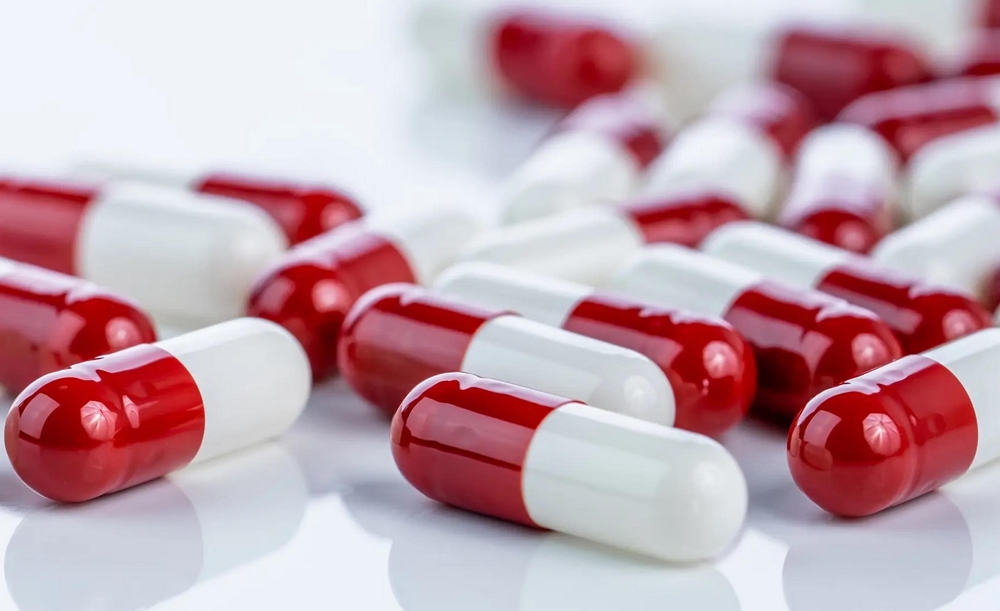 Red and white gelatin capsules prepared for quality review